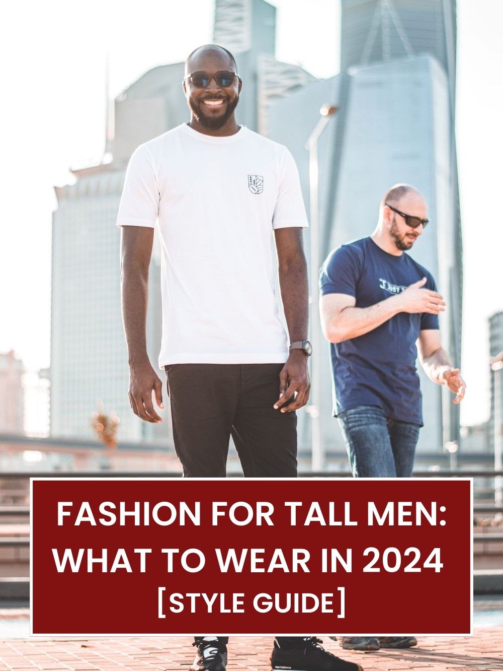 Two tall slim men standing in the street and wearing extra long tall graphic t-shirts.