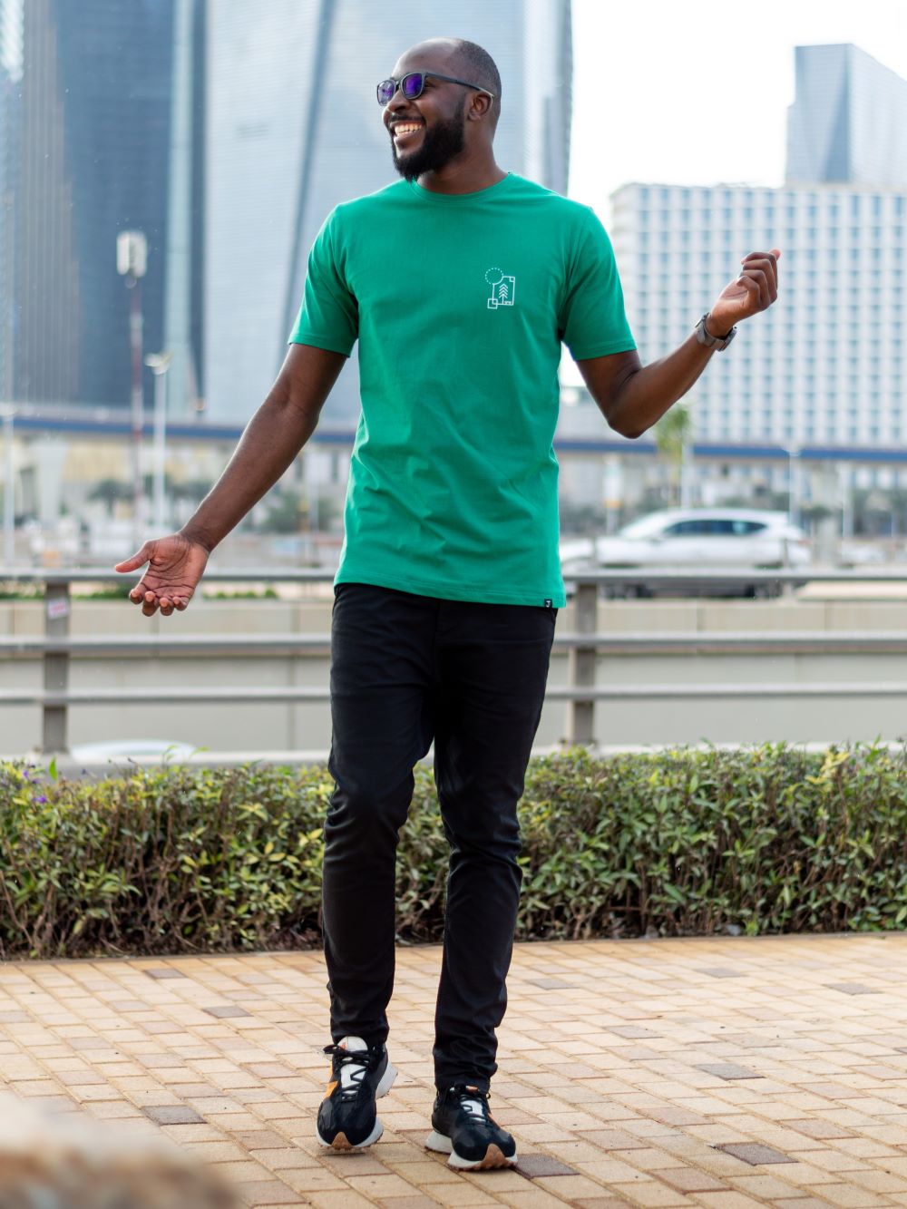 A tall skinny guy in a green tall slim t-shirt.