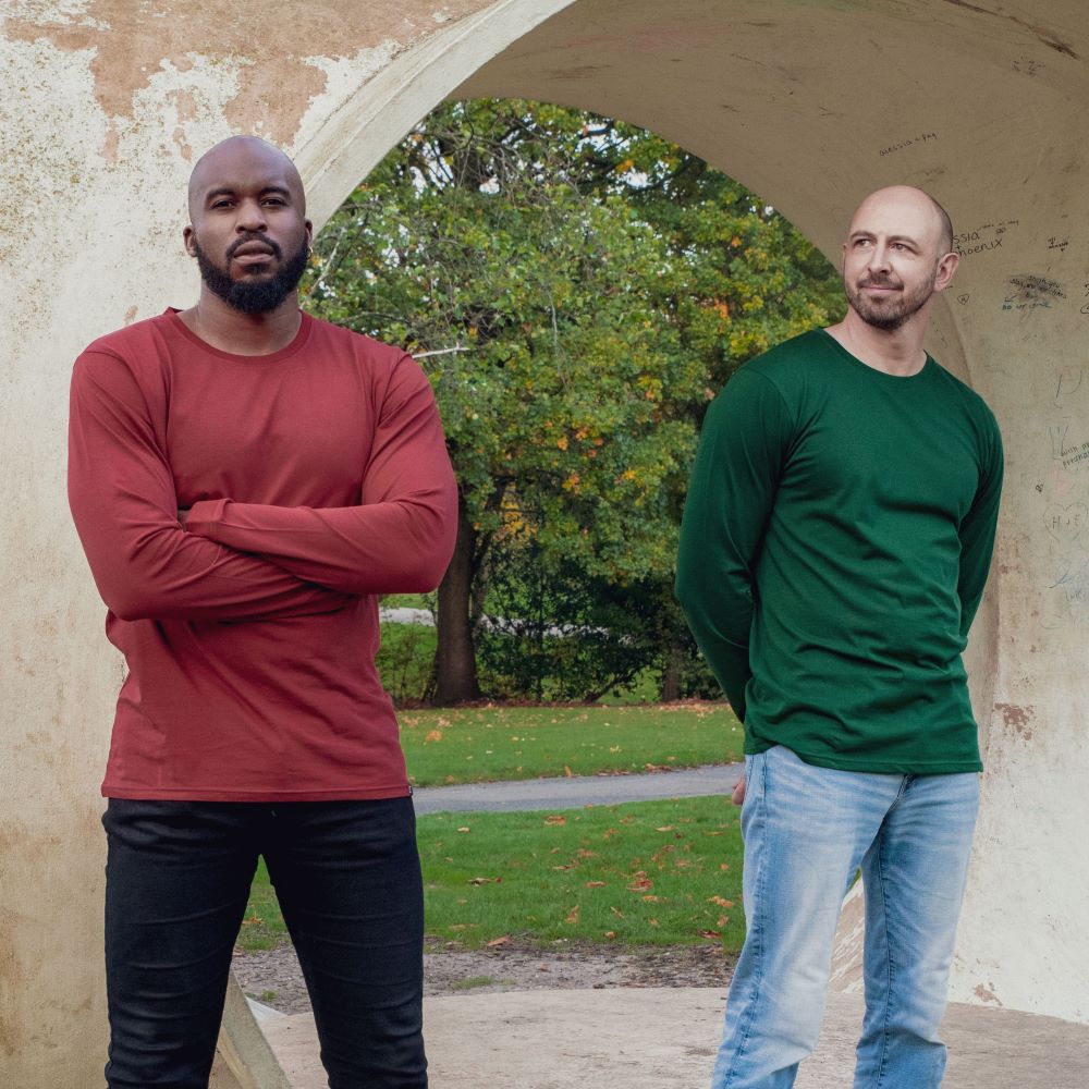 Two tall slim guys wearing tall long sleeve t-shirts in dark orange and dark green.