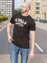 Thumbnail for A tall skinny guy, hand in pocket, wearing a tall slim graphic t-shirt.