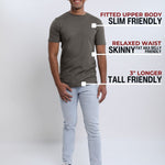 A head to toe shot of a tall slim guy  in a studio and wearing a dark grey medium tall slim t-shirt.