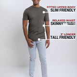 A head to toe shot of a tall slim guy in a studio and wearing a dark grey medium tall slim t-shirt.