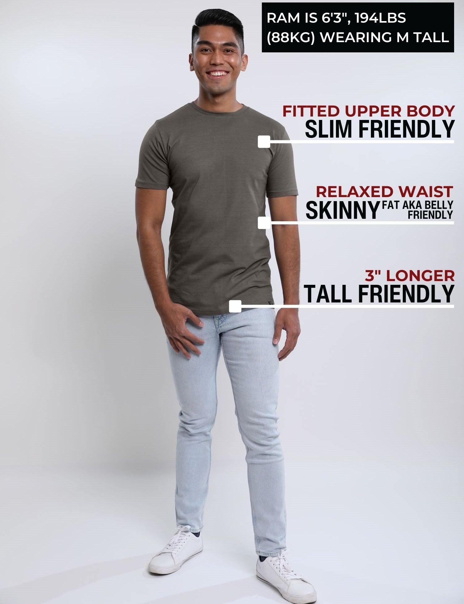 A head to toe shot of a tall slim guy  in a studio and wearing a dark grey medium tall slim t-shirt.