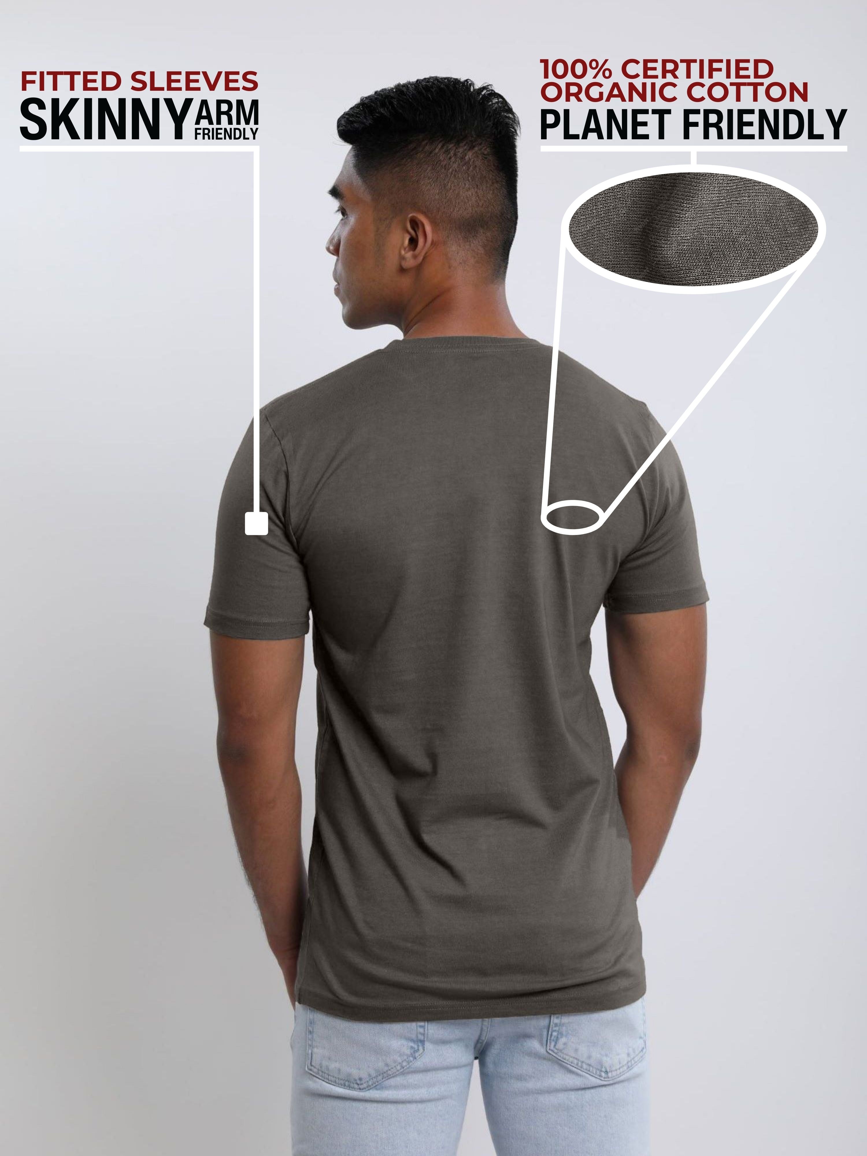 A shot from behind of a tall and slim guy in a studio and wearing a dark grey medium tall slim t-shirt.