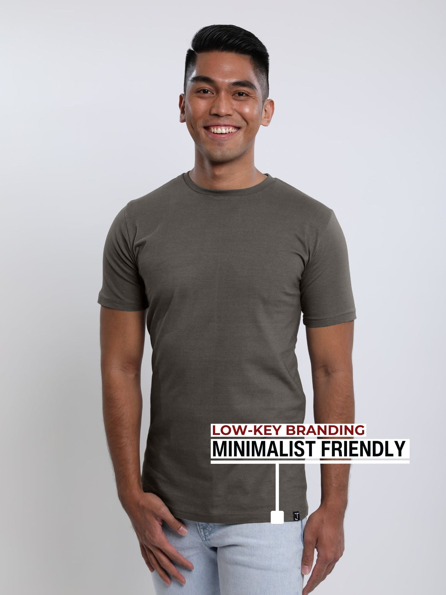 An upper body shot of a tall slim guy wearing a dark grey medium tall t-shirt.