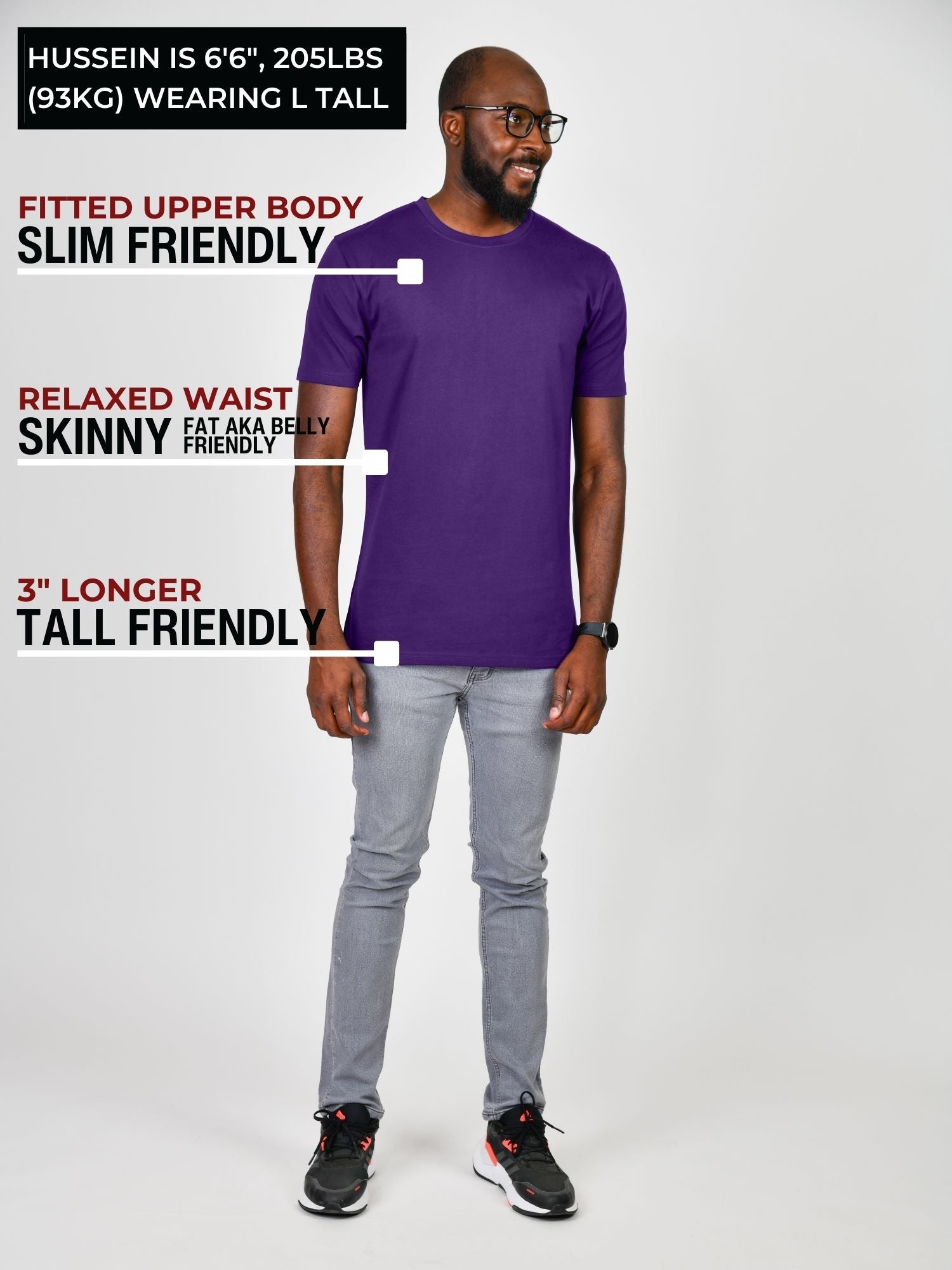 A head to toe shot of a tall slim guy in a studio and wearing a royal purple large tall slim t-shirt.