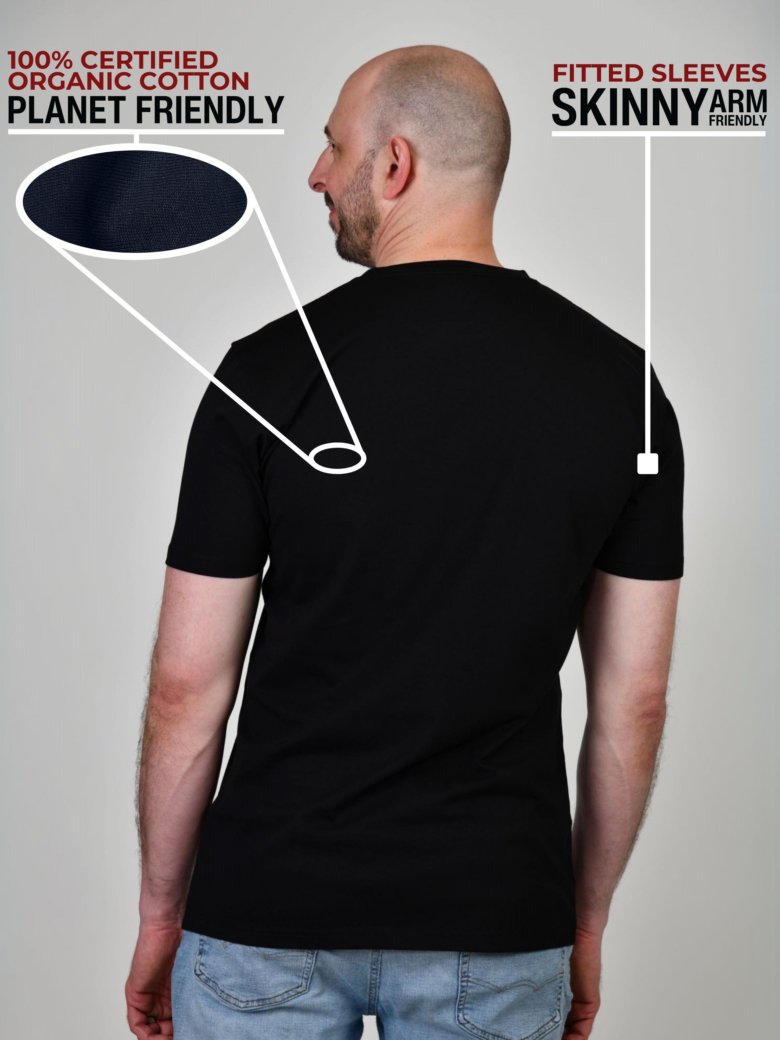 A shot from behind of a tall and slim guy in a studio and wearing a black XL tall slim t-shirt.