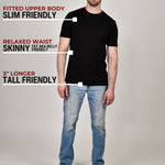 A head to toe shot of a tall muscular guy  in a studio and wearing a black XL tall t-shirt.
