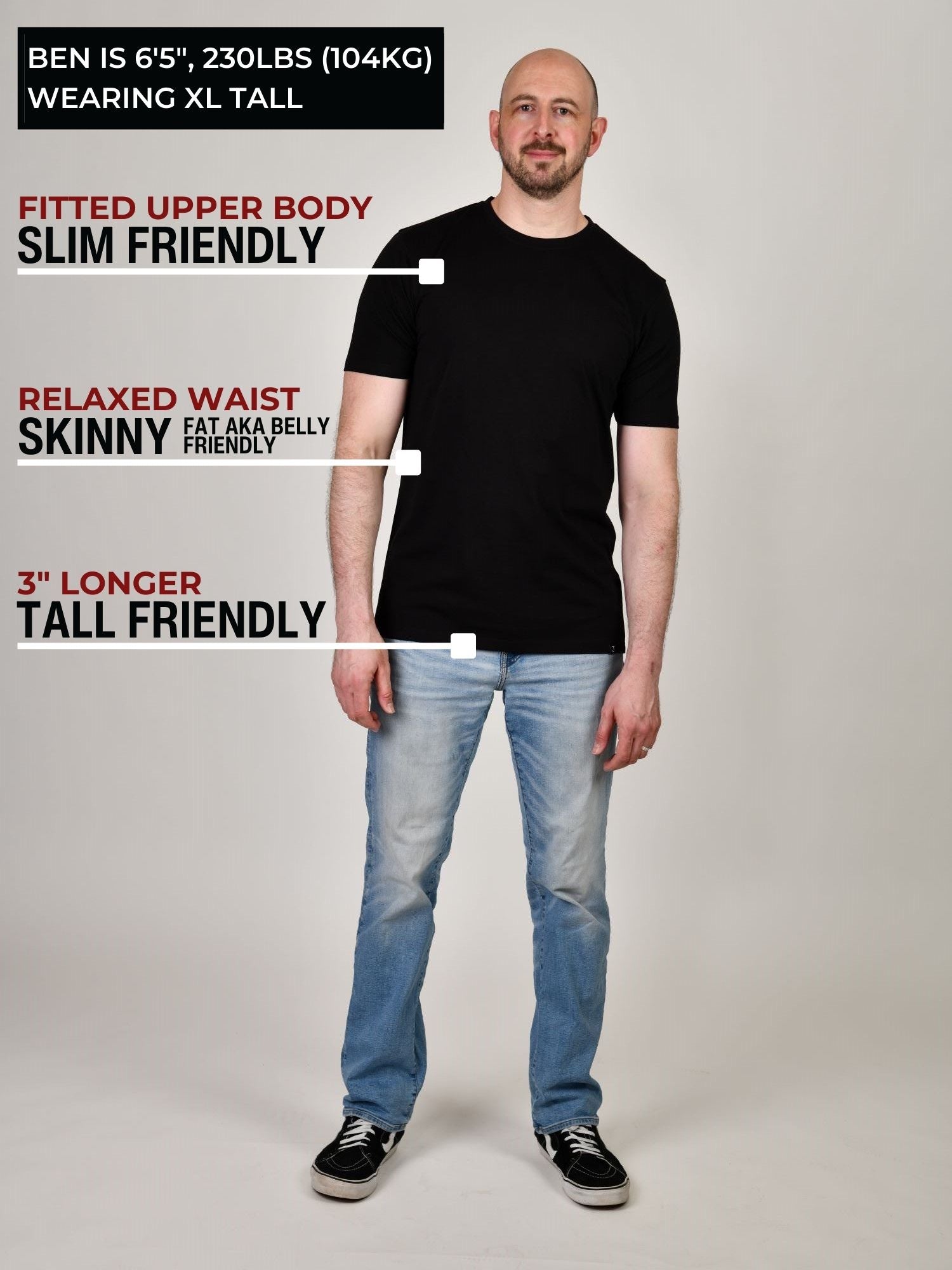 A head to toe shot of a tall muscular guy in a studio and wearing a black XL tall t-shirt.