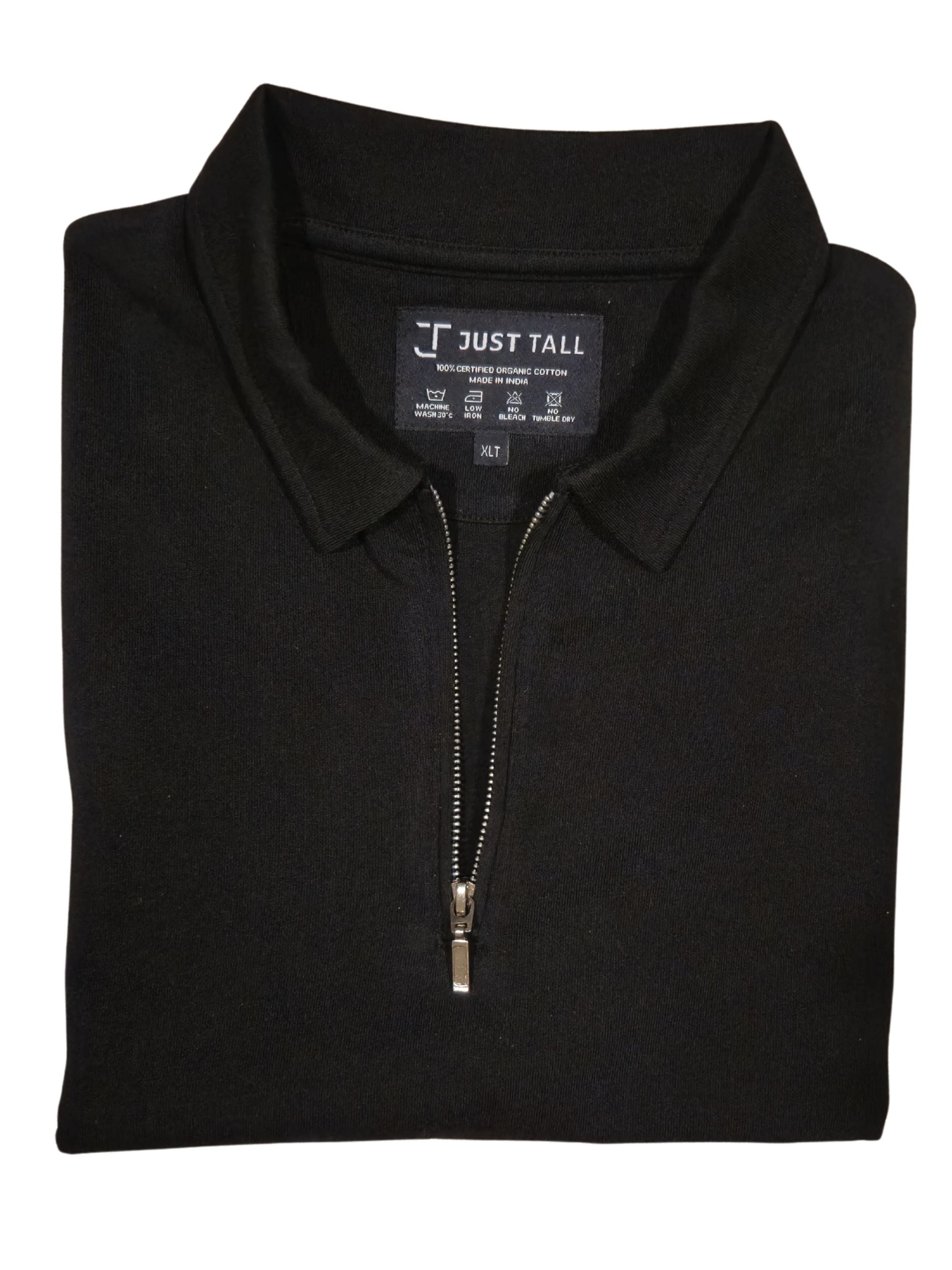 Folded black polo shirt with a zipper on a white background, featuring 'Just Tall' brand label.