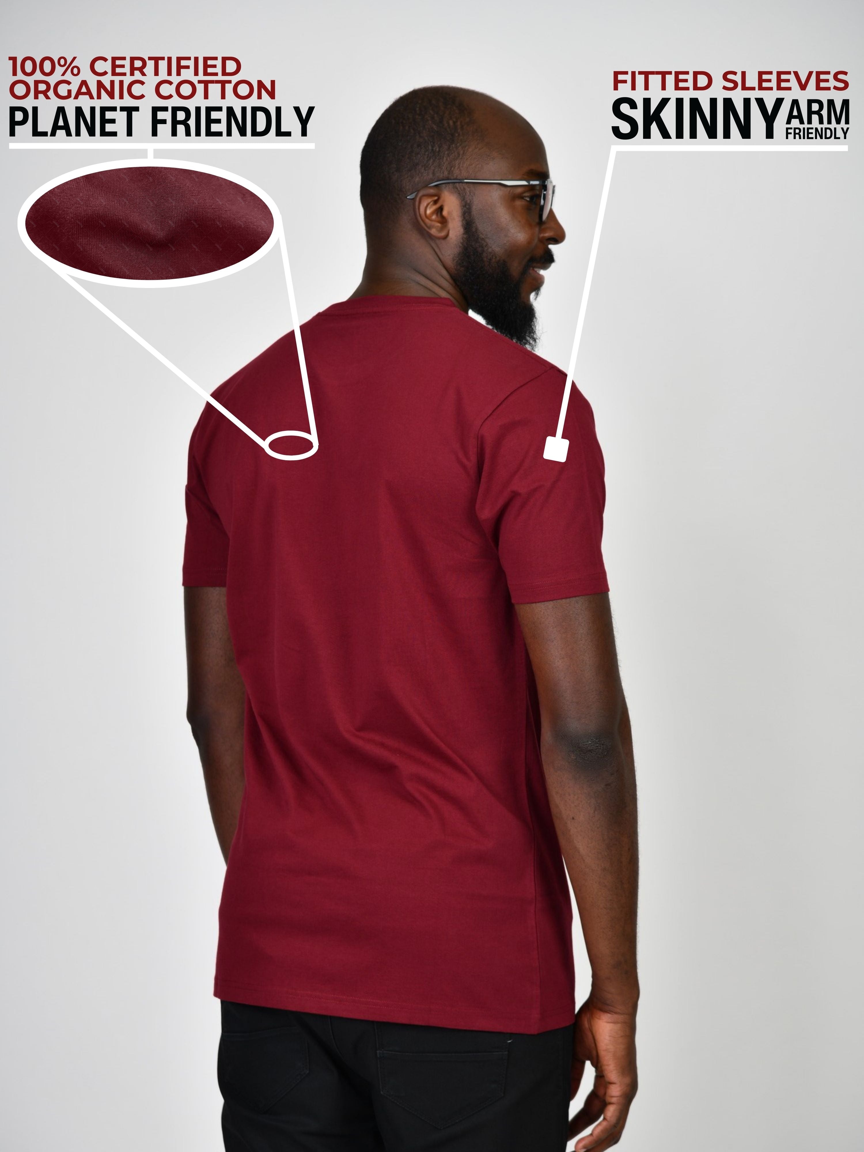 A shot from behind of a tall and slim guy in a studio and wearing a cabernet large tall slim t-shirt.