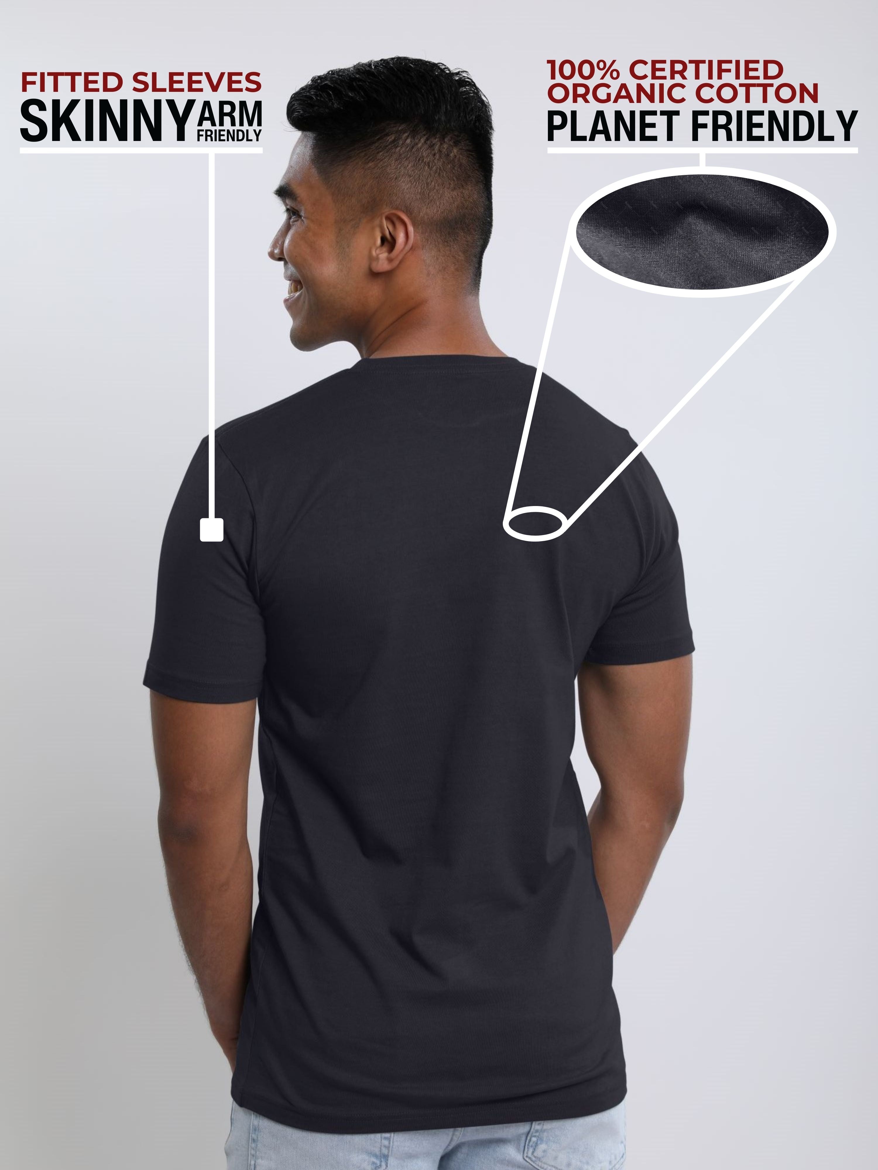 A shot from behind of a tall and slim guy in a studio and wearing a charcoal medium tall slim t-shirt.