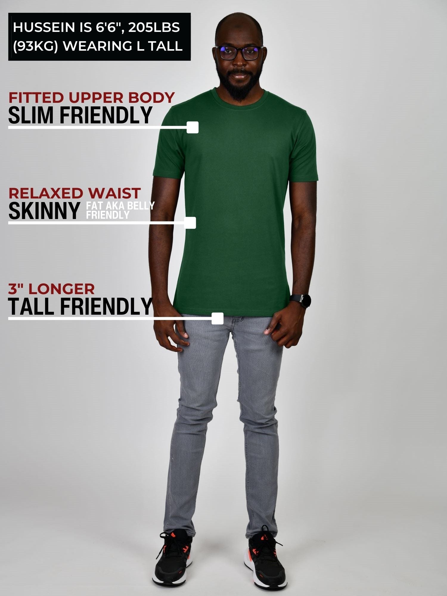 A head to toe shot of a tall slim guy in a studio and wearing a royal purple large tall slim t-shirt.