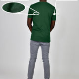 A shot from behind of a tall and slim guy in a studio and wearing a dark green large tall slim t-shirt.