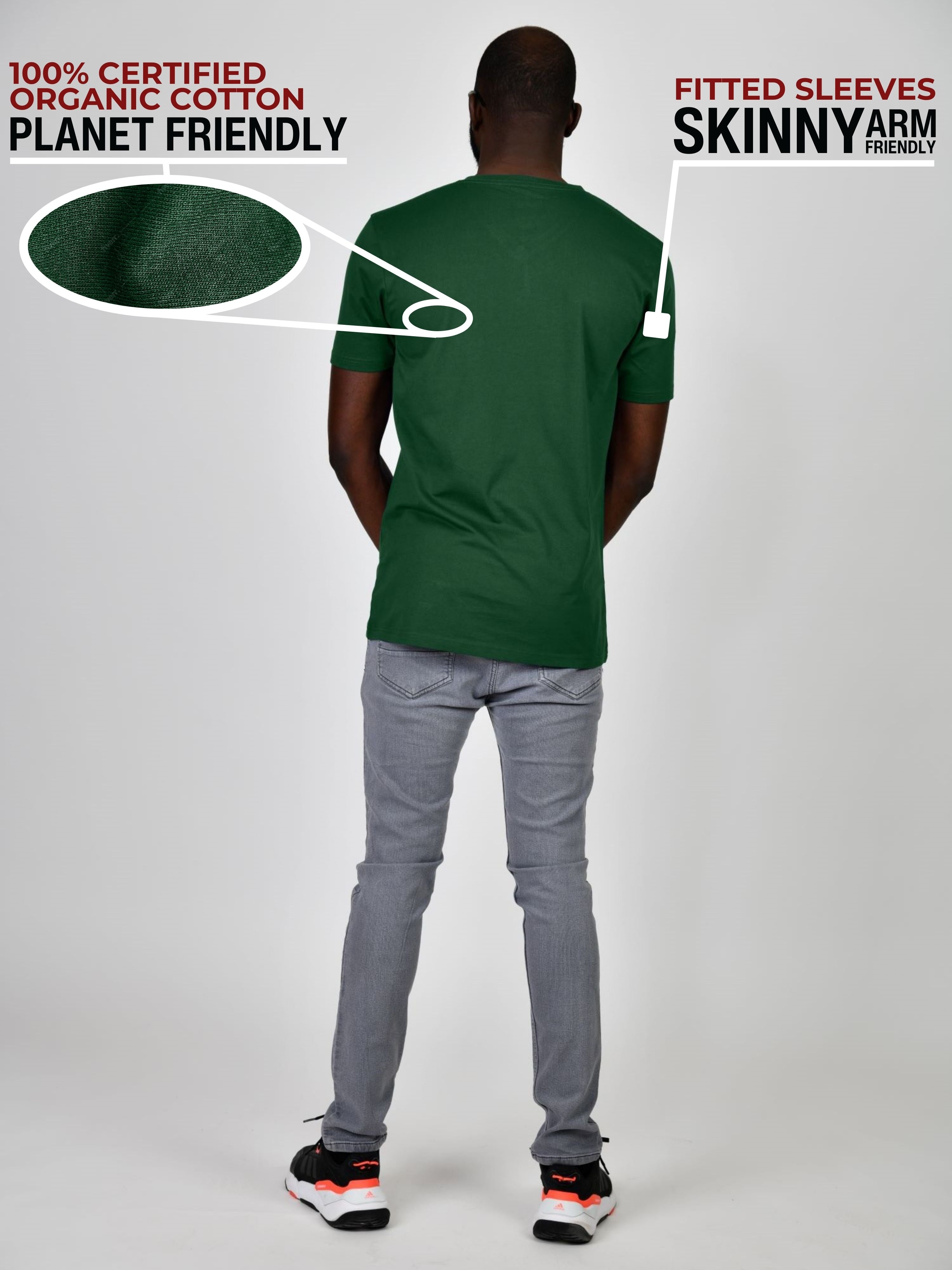 A shot from behind of a tall and slim guy in a studio and wearing a dark green large tall slim t-shirt.