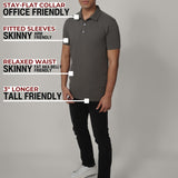 A head to toe shot of a tall slim man in a studio wearing a dark grey medium tall polo shirt.