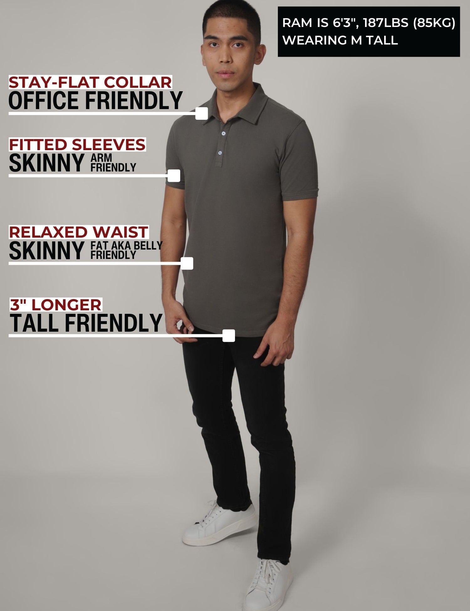 A head to toe shot of a tall slim man in a studio wearing a dark grey medium tall polo shirt.