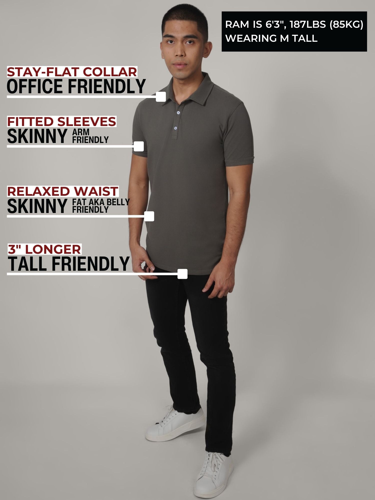 A head to toe shot of a tall slim man in a studio wearing a dark grey medium tall polo shirt.