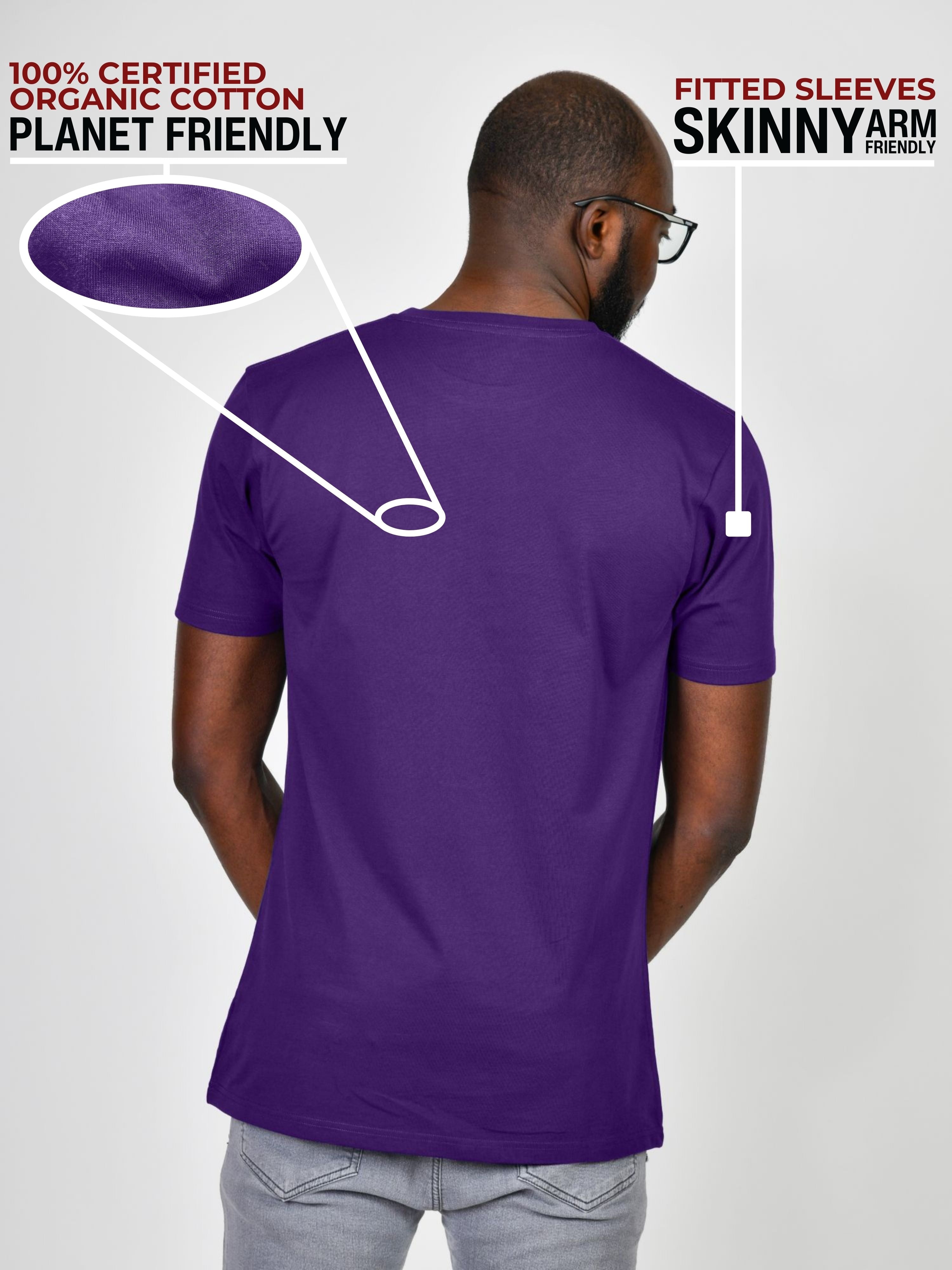 A shot from behind of a tall and slim guy in a studio and wearing a dark purple large tall slim t-shirt.
