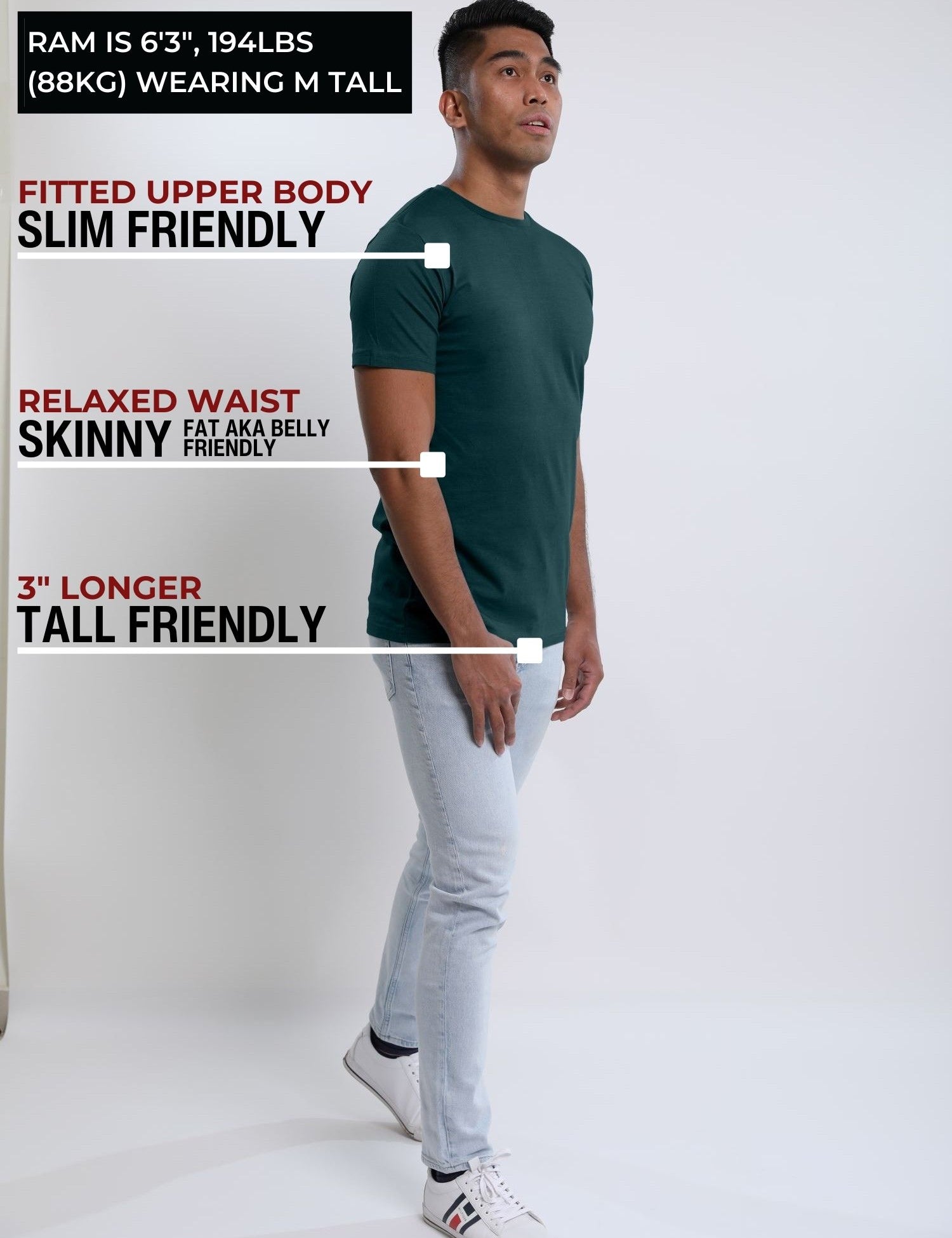 A head to toe shot of a tall slim guy  in a studio and wearing a dark teal medium tall slim t-shirt.
