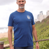A tall and slim man standing by the sea. The smiling model is wearing a navy blue extra long graphic t-shirt with a minimal lake design. It features a 3" longer body, 100% organic cotton, and is soft & preshrunk. This extra long tall graphic tee is ideal for tall slim men 6'2"+