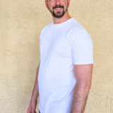 A tall slim man wearing an XL tall heavyweight white t-shirt.