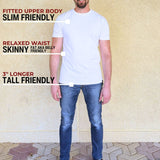 A head to toe shot of tall slim man wearing an XL tall heavyweight white t-shirt.