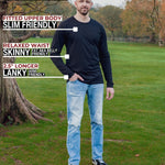 A head to toe shot of a tall athletic guy in a park wearing a black long sleeve tall t-shirt.