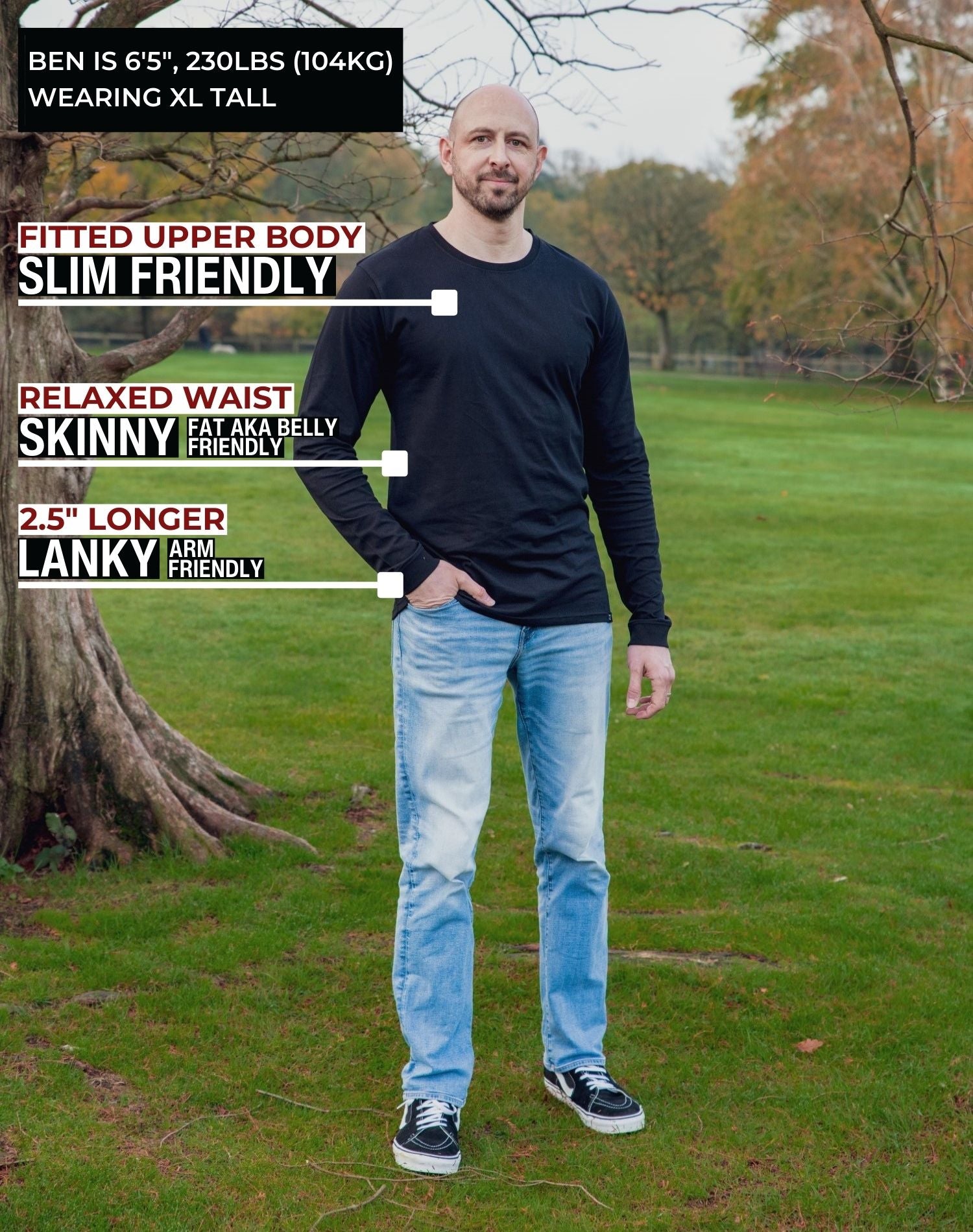A head to toe shot of a tall athletic guy in a park wearing a black long sleeve tall t-shirt.