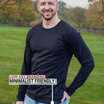 An upper body shot of a tall athletic guy standing in a park wearing a black extra long tall long sleeve t-shirt and showing the Just Tall minimalist monogram logo.