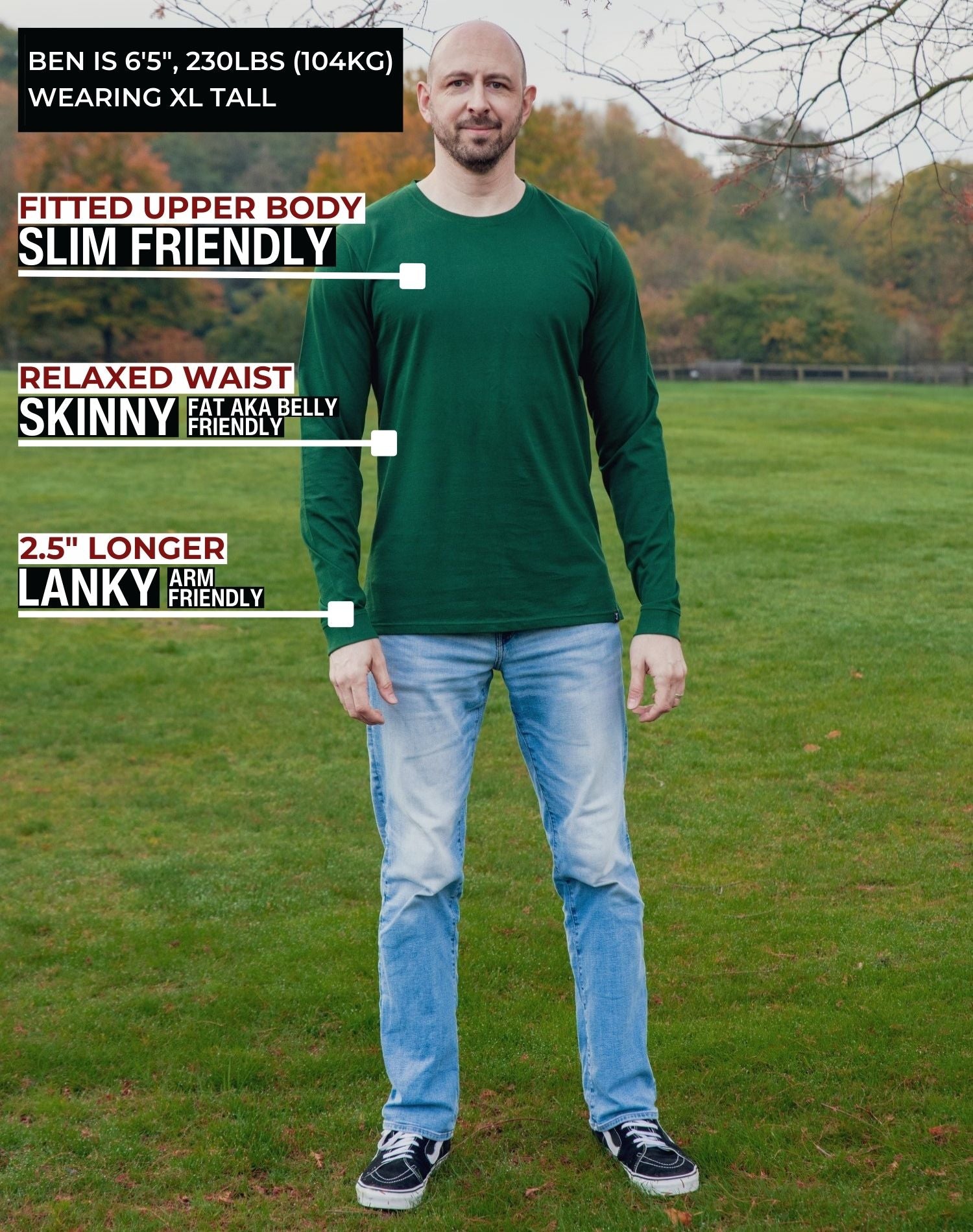 A head to toe shot of a tall athletic guy in a park wearing a dark green long sleeve tall t-shirt.