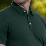 A close-up of the stay-flat collar of a tall dark pine polo shirt.