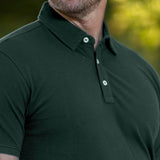 A close-up of the stay-flat collar of a tall dark pine polo shirt.