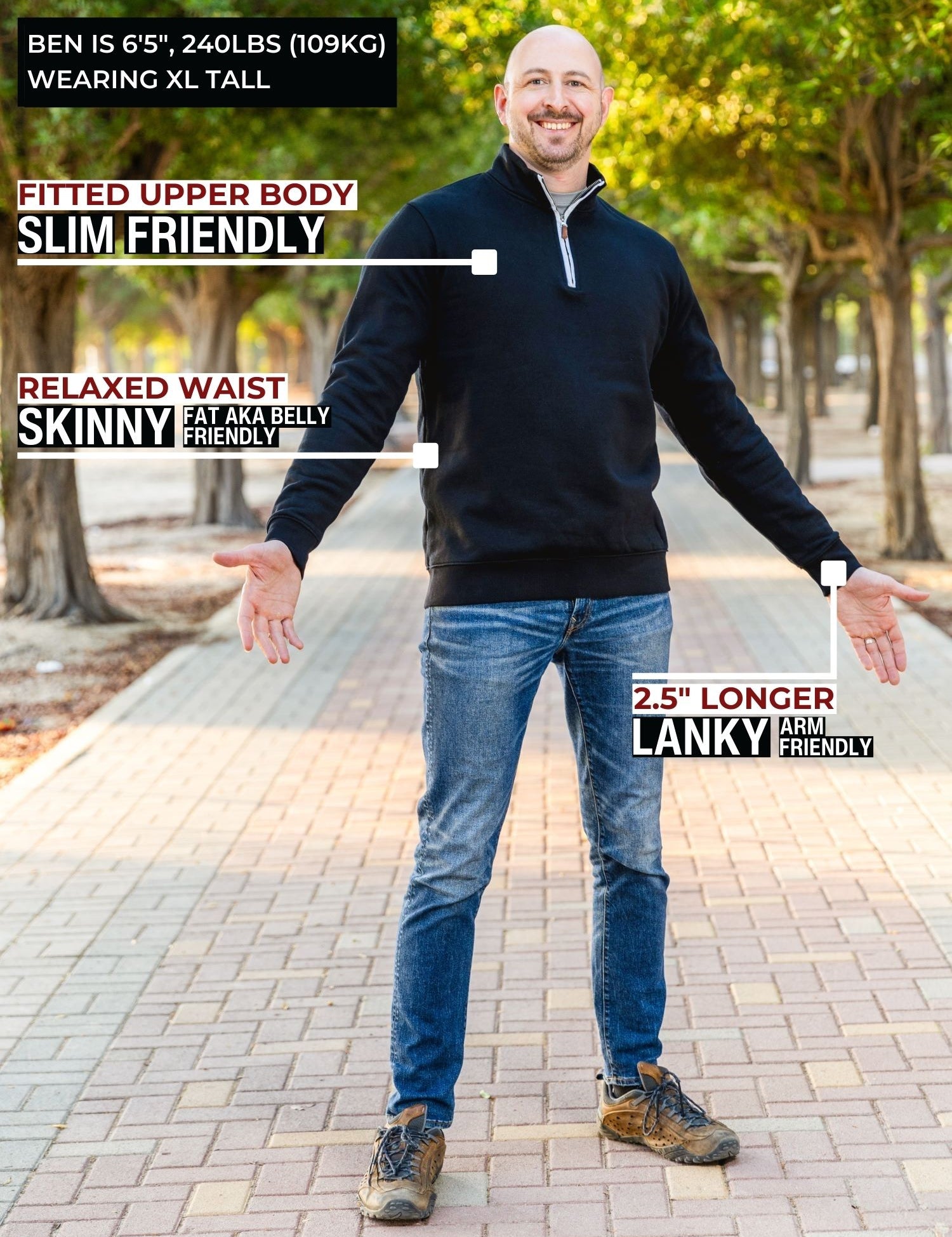 A head to toe shot of a tall athletic guy in a park wearing an XL tall extra long black quarter zip sweatshirt.
