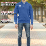 A head to toe shot of a tall athletic guy in a park wearing an XL tall extra long cobalt quarter zip sweatshirt.