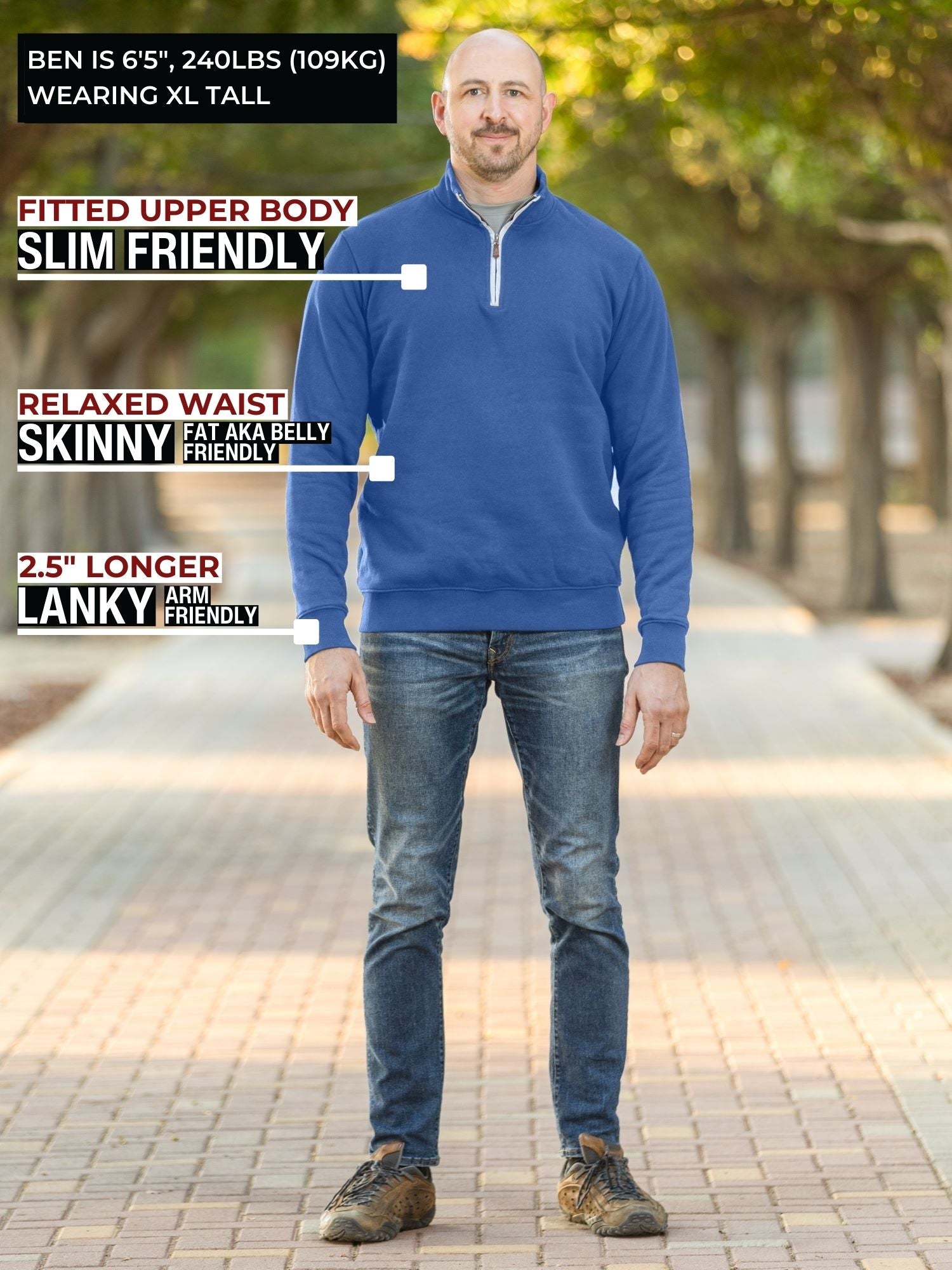 A head to toe shot of a tall athletic guy in a park wearing an XL tall extra long cobalt quarter zip sweatshirt.