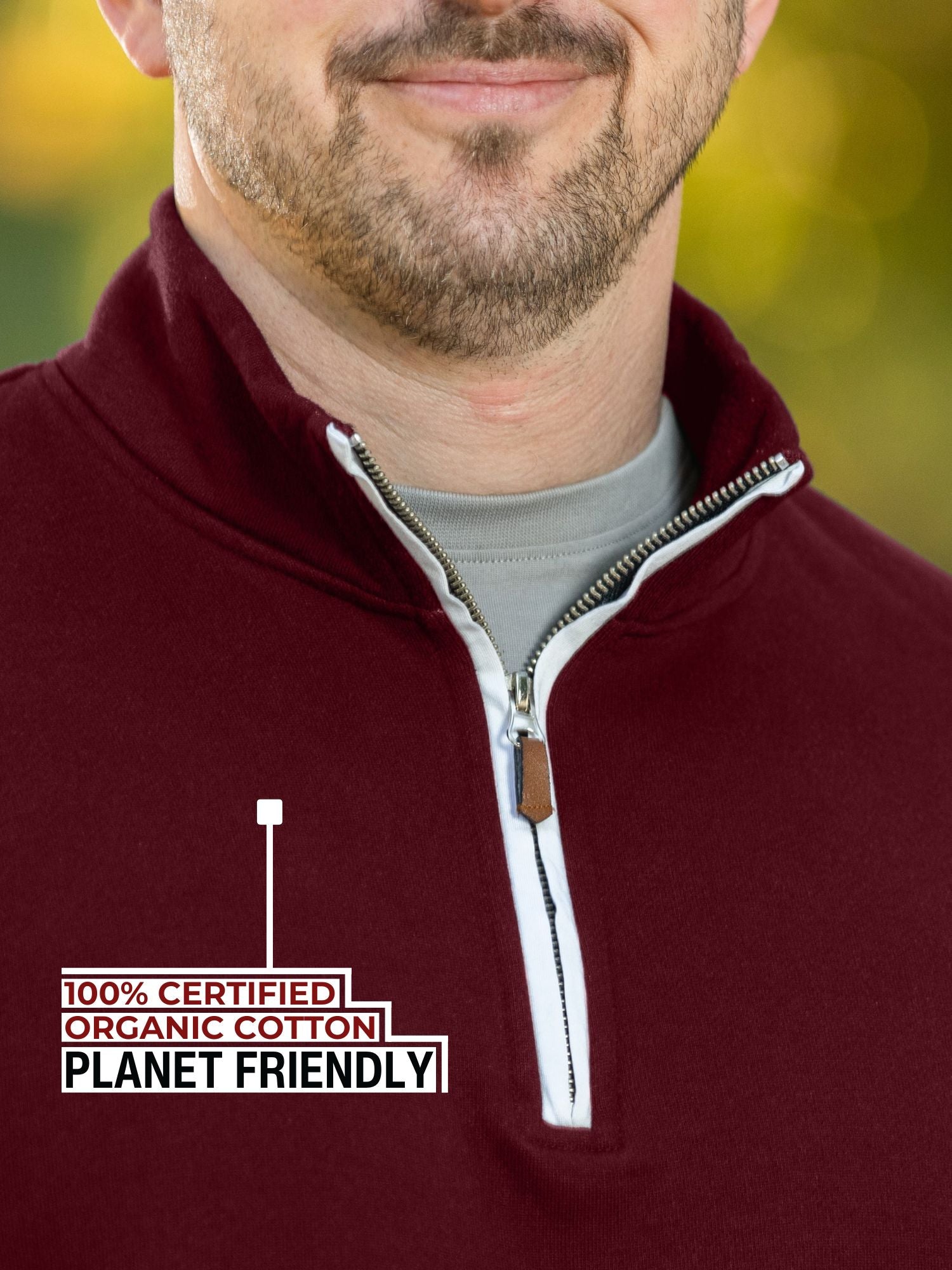 A close-up of the tall maroon quarter zip collar and the durable metal zipper.