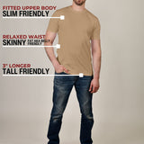 A head to toe shot of a tall slim guy in a studio and wearing a tan XL tall slim t-shirt.