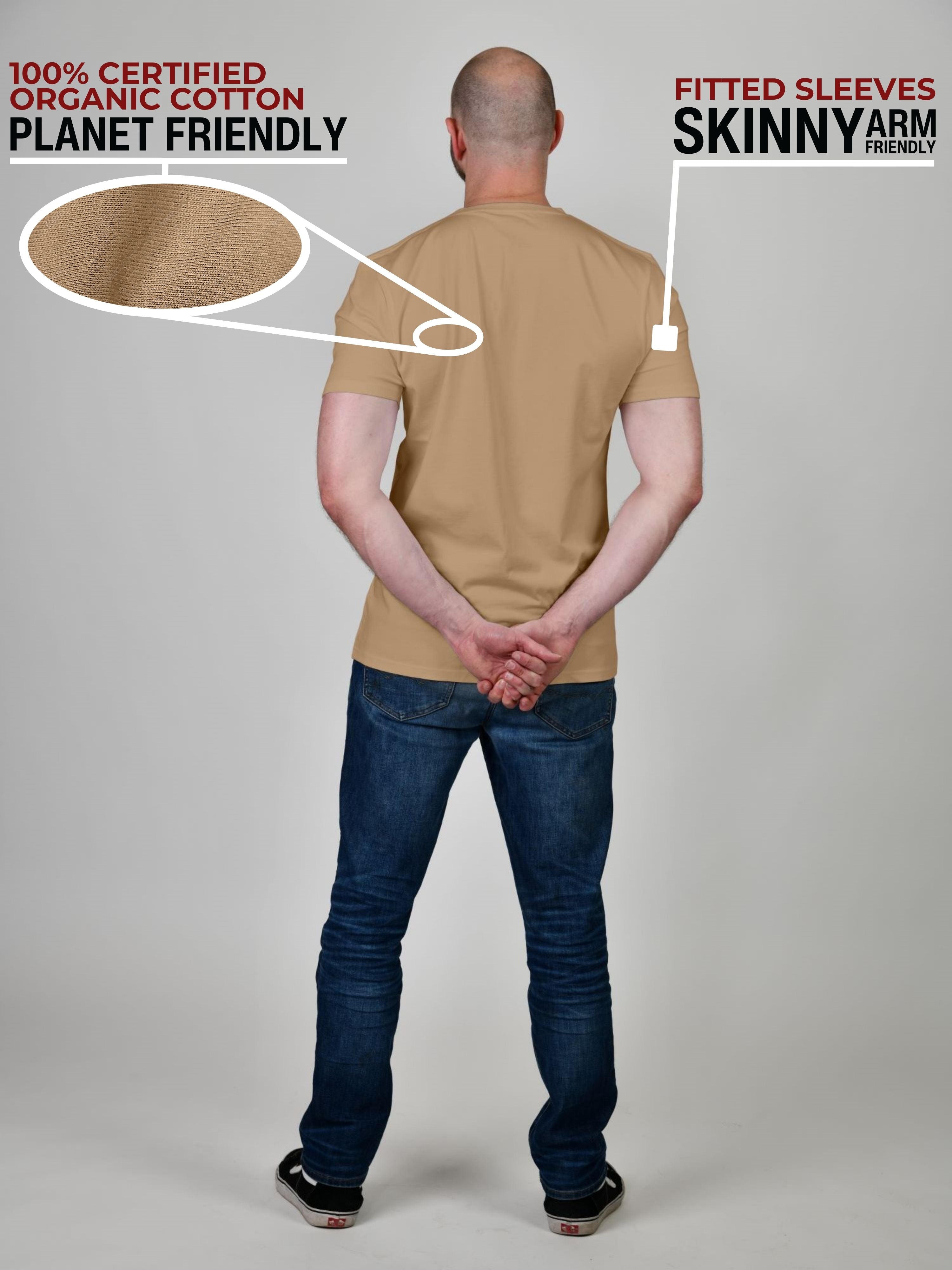 A shot from behind of a tall and athletic guy in a studio and wearing a tan XL tall slim t-shirt.