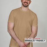 An upper body shot of a tall athletic guy in a studio and wearing a tan extra large tall slim t-shirt.