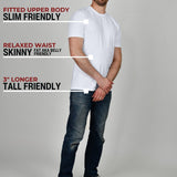 A head to toe shot of a tall muscular guy in a studio and wearing a white XL tall t-shirt.