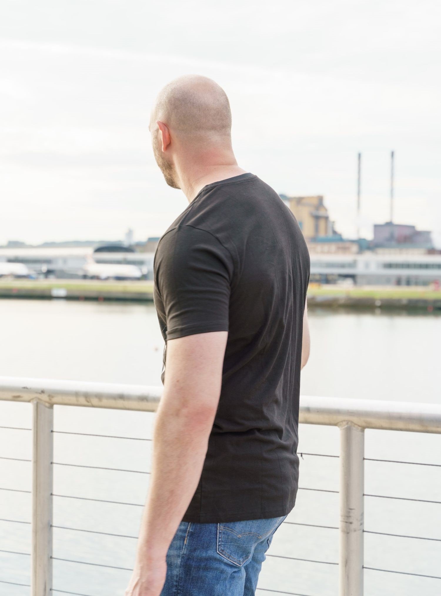 A tall skinny guy wearing a tall slim black t-shirt