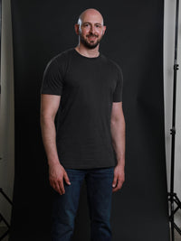 Thumbnail for A tall and slim guy in the studio wearing a charcoal XL tall slim t-shirt.