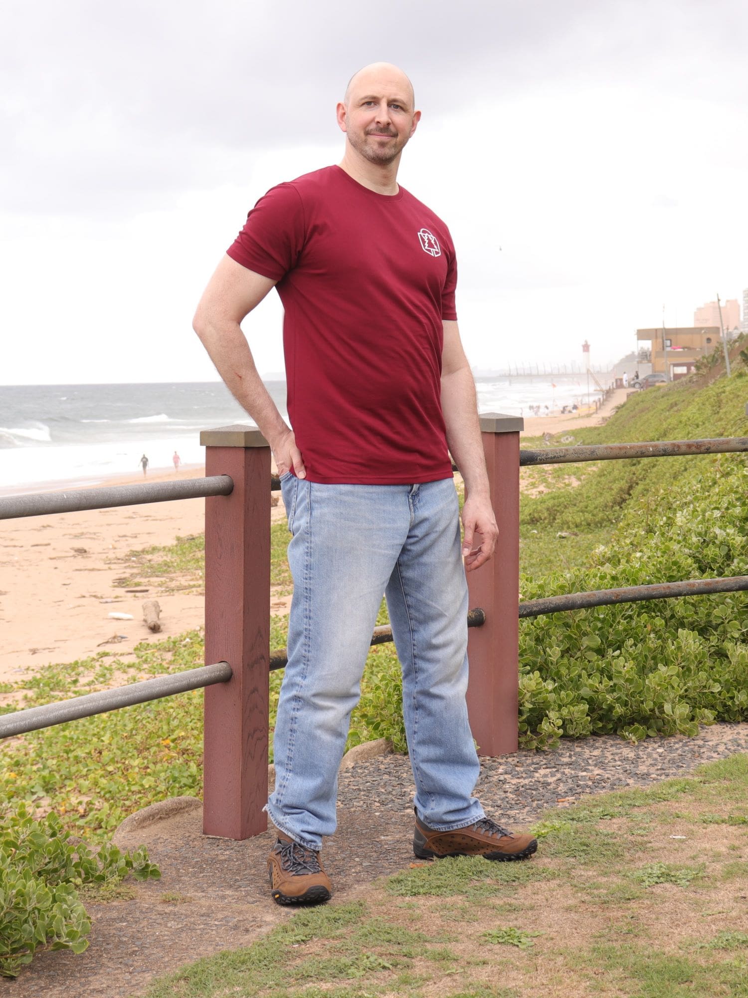 A head to toe shot of a tall slim guy wearing an XL tall graphic t-shirt with a tree design.