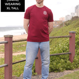 A head to toe shot of a tall skinny guy wearing an XL tall graphic t-shirt with a tree design.