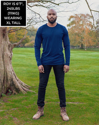 Thumbnail for A head to toe shot of a tall athletic guy in a park wearing a navy long sleeve tall t-shirt.