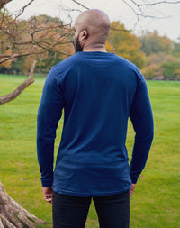 Thumbnail for A shot from behind of a tall athletic guy wearing a long sleeve navy tall t-shirt.
