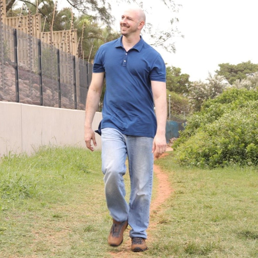 A tall athletic guy wearing a navy XL tall polo shirt.