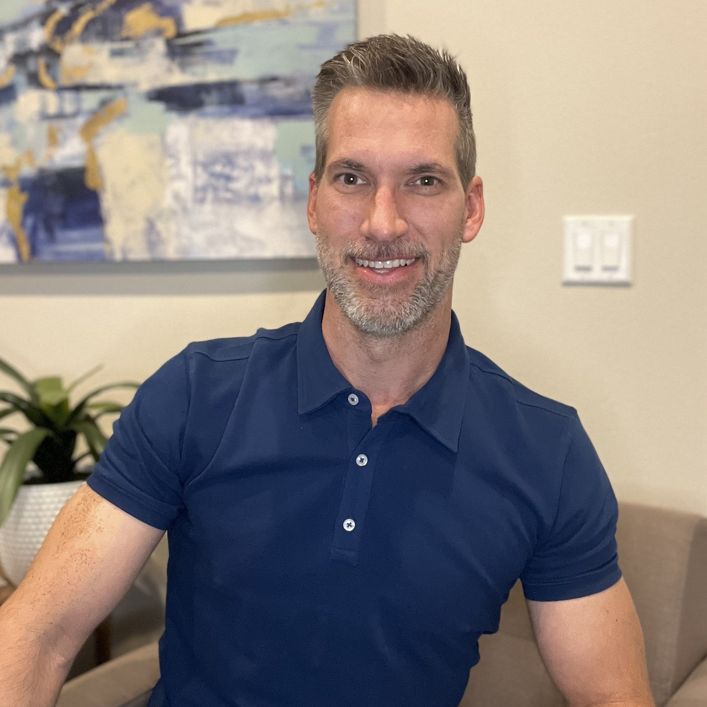 A tall slim guy wearing a medium tall navy polo shirt.
