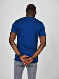 Thumbnail for A shot from behind of a tall and slim guy in the studio and wearing a navy blue L tall slim v-neck t-shirt.